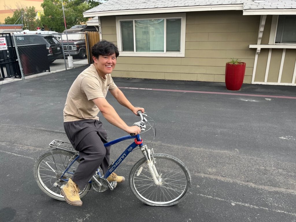 A burner riding his bike through the Linden Mini Storage lot