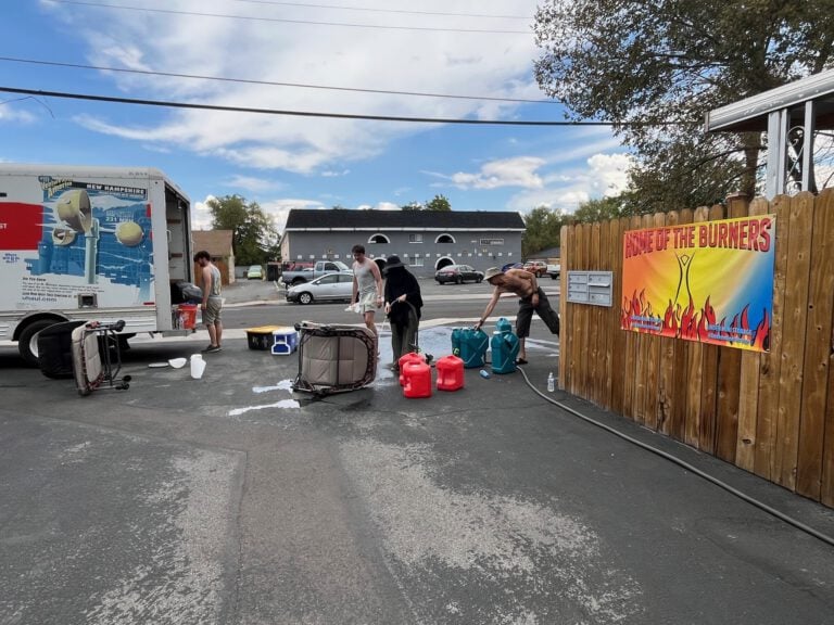 Burners washing down gear and gas cans after Burning Man