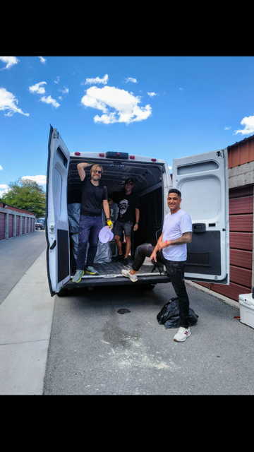 Burners unloading a rental van at their storage unit