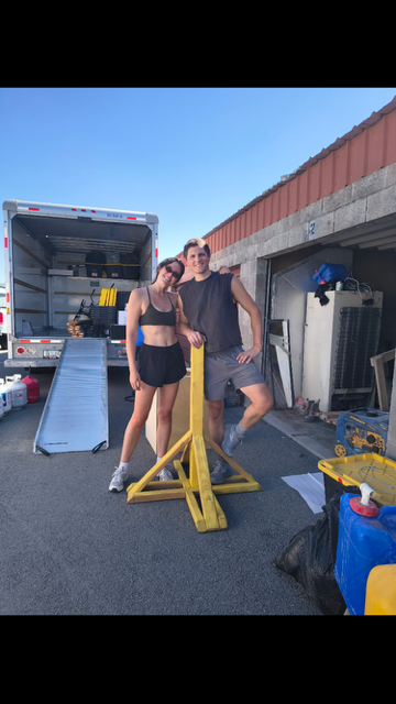 A couple with moving equipment at Linden Mini Storage